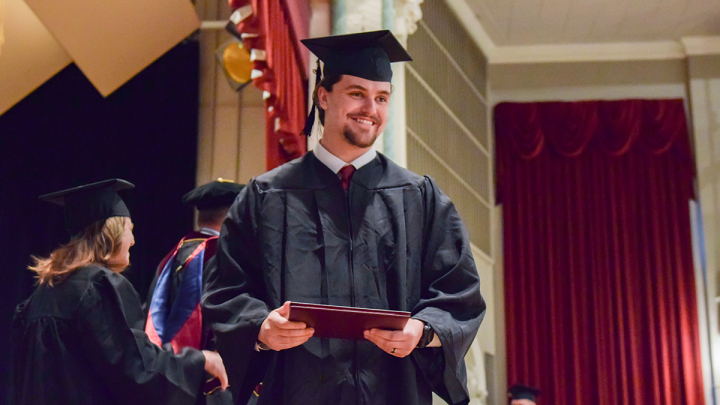 VCSU student receiving diploma at commencement ceremony
